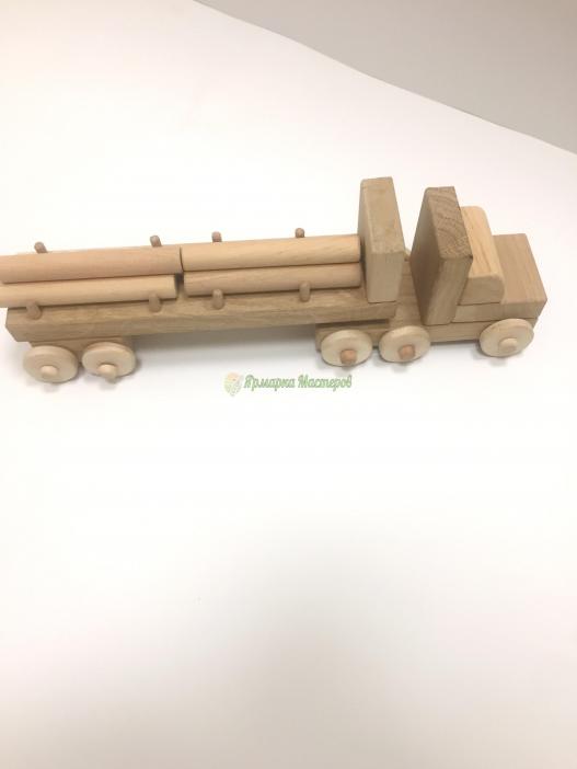 <div style=margin-left:10px><h1>Деревянная машина Тягач В 12</h1><p><a href="/catalog/ukrasheniya/">Прикраси</a> » <a href="/catalog/ukrasheniya/igrushki/">Iграшки</a></p><i class="fa fa-map-marker"></i> Киевская область, Киев<br /><br /><div class="socdata"><script src="//yastatic.net/es5-shims/0.0.2/es5-shims.min.js"></script>
                                            <script src="//yastatic.net/share2/share.js"></script>
                                            <div class="ya-share2" data-services="facebook,gplus,twitter,lj,viber,whatsapp,skype" data-counter=""></div></div>